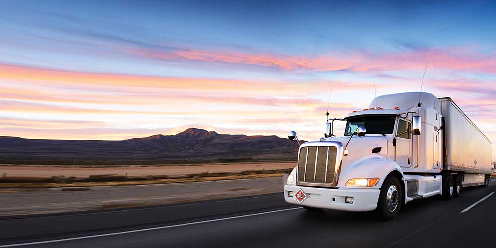 Truck Driving on highway at sunset