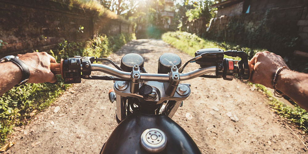 Riding motorcycle on dirt road