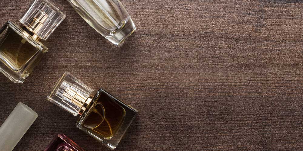 Different bottle of perfume on a wooden table